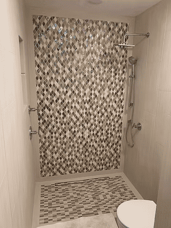 Modern bathroom with a stylish mosaic tile shower and sleek fixtures.