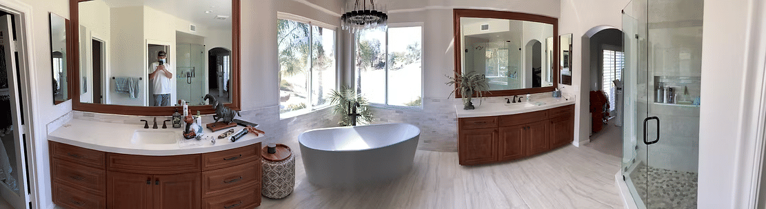 Spacious luxury bathroom with dual vanities, large soaking tub, and natural light.