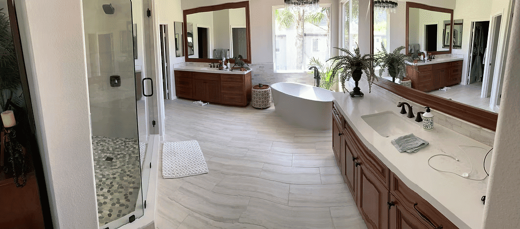 Spacious modern bathroom with a freestanding tub, double vanities, and glass shower.
