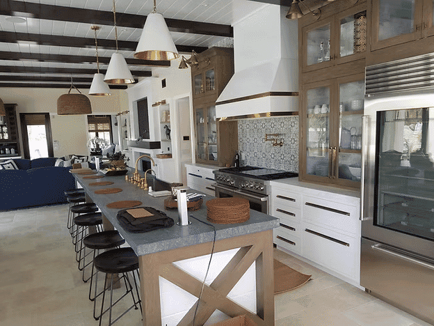 Modern kitchen with an island, pendant lights, and stylish cabinets, featuring a sleek design.