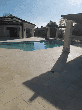 Luxury backyard pool with modern architecture and sunlit patio. Perfect for relaxation and entertainment.
